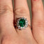 Oval Cut Emerald & Round Brilliant Cut Diamond Cluster Engagement Ring