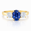 Oval Cut Sapphire with Round Brilliant Cut Diamond Side Stones Trilogy Ring
